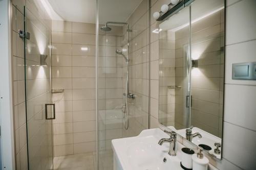 a bathroom with a sink and a shower at Garden Apartment in Cēsis