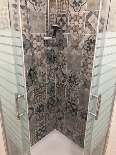 a shower with a glass door in a bathroom at La Ruota B&B in Terrasini