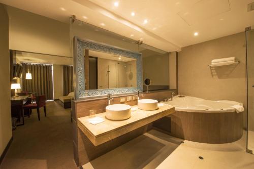 a bathroom with a sink and a large mirror at Arawi Miraflores Prime in Lima