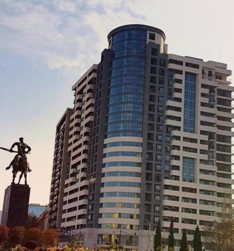 a large building with a statue in front of it at Mia B&B Tbilisi in Tbilisi City