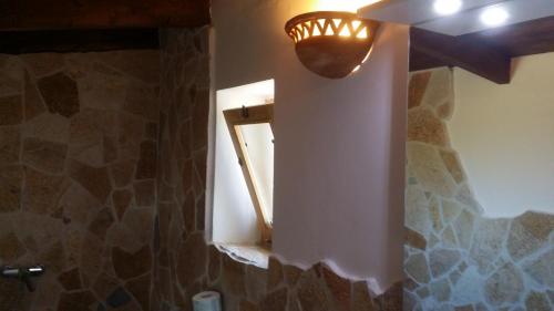 ガリポリにあるAgriturismo Tenuta La Siestaの窓付きのバスルーム、壁に照明が付いています。