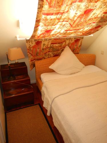 a bedroom with a bed and a ceiling with a painting at Hotel Villa Meererbusch in Meerbusch