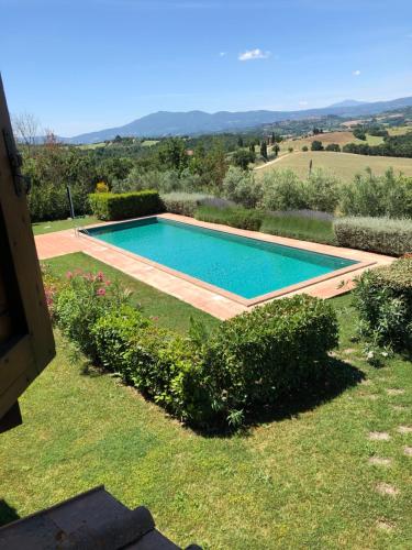 a swimming pool in the yard of a house at Casale Umbro in Castiglione del Lago