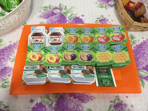 an orange tray with a bunch of snacks on it at B&B San Francesco di Paola in Vittoria