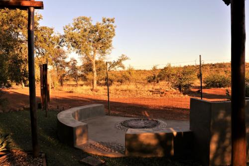 a fire pit in the middle of a field at Ngalali Retreat in Grietjie Nature Reserve