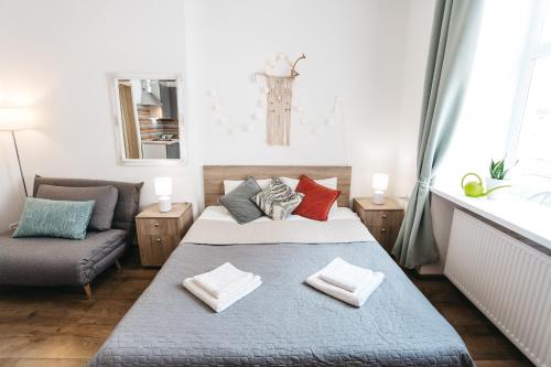 a bedroom with a bed and a couch at "Green Oasis Apartment" in Lviv