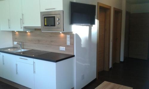 a kitchen with a sink and a microwave at Ladis Living in Ladis