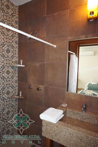 a bathroom with a shower with a sink and a mirror at Casa Esmeralda Hotel in Oaxaca City