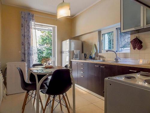 a kitchen with a small table and chairs in it at Nea Filadelfia- Spacious Apartment with Garden in Athens