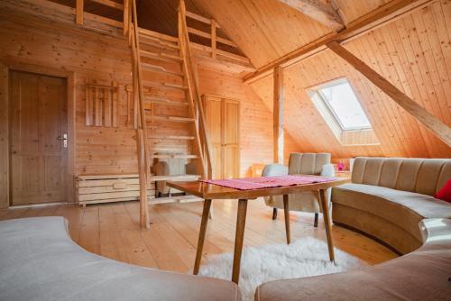 a room with a table in a wooden cabin at Chata Magurka in Partizánska ľupča