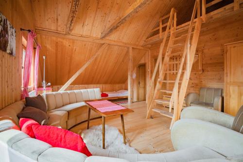 a living room with couches and a ladder in a cabin at Chata Magurka in Partizánska ľupča