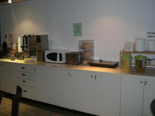 a kitchen with a counter with a microwave on it at Howard Johnson by Wyndham Niagara Falls in Niagara Falls