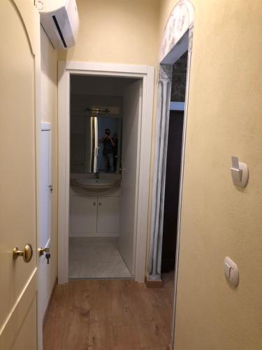 a person taking a picture of a bathroom with a mirror at Alloggi per uso turistico A&M in Acquapendente
