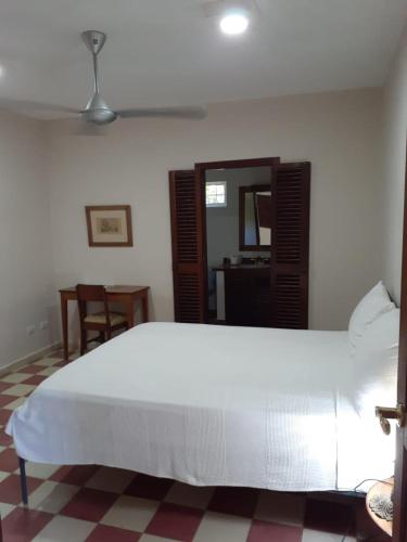 a bedroom with a large white bed in a room at Villa Carolina Bed and Breakfast in San Felipe de Puerto Plata