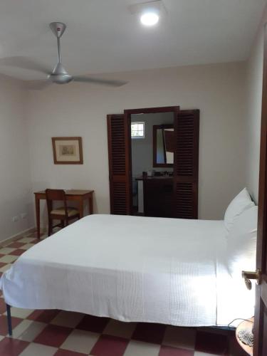 a bedroom with a large white bed in a room at Villa Carolina Bed and Breakfast in San Felipe de Puerto Plata