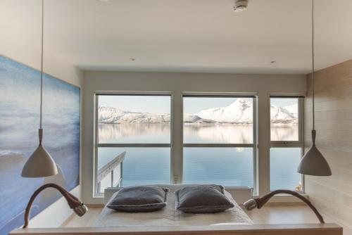 a room with a bed with a large window at Malangen Resort in Mestervik