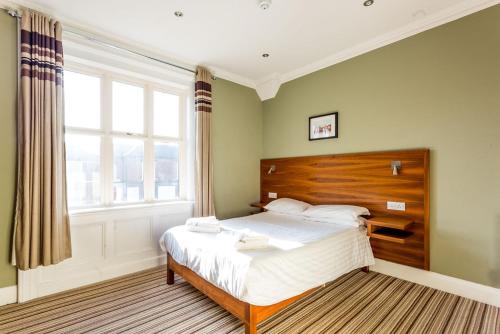 a bedroom with a bed and a large window at Bawn Lodge in Chester