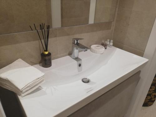 a bathroom with a white sink and a mirror at River Inn Arco in Arco