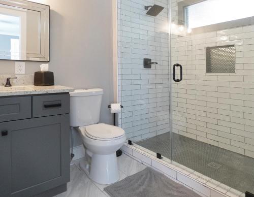 a bathroom with a toilet and a glass shower at Modern Bungalow Near Downtown in Atlanta