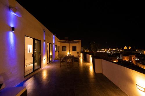 a balcony of a building at night with lights at Penthouse Retreat in Cospicua