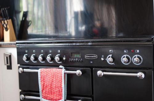 a black oven with a red and white towel on it at Cyrus House in Dartford