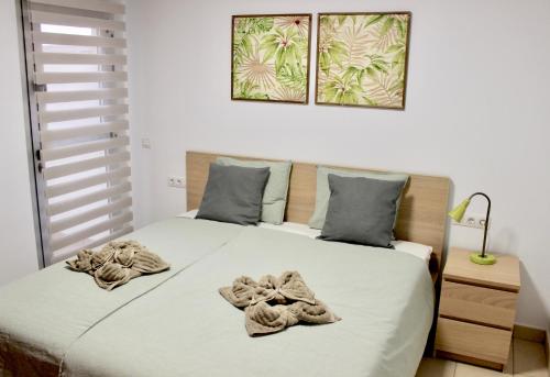 a bedroom with a bed with towels on it at Brilliant 2BDR Apartment in Poris de Abona