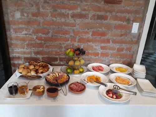 a table with many different dishes of food on it at Carlota Sustainable Design Hotel in Quito