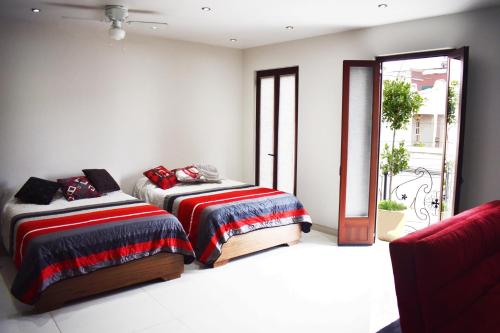 En eller flere senge i et værelse på En el Centro 3 Hermoso Loft Familiar AC WiFi 300 mbps