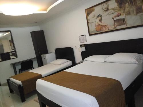 Ένα ή περισσότερα κρεβάτια σε δωμάτιο στο Hotel Plaza Norte Cali