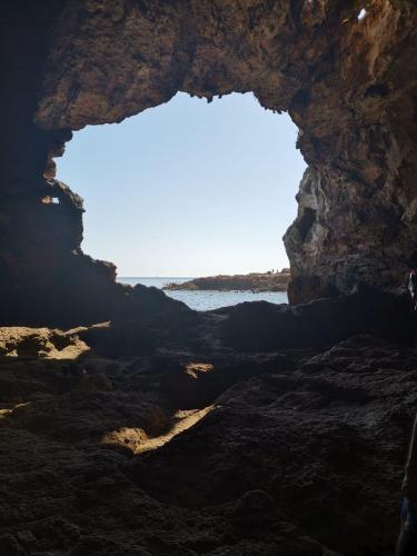 a cave with the ocean in the background at Guesthouse Berna in Denia