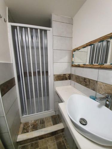 a bathroom with a white sink and a shower at B&B città del carrubo in Rosolini