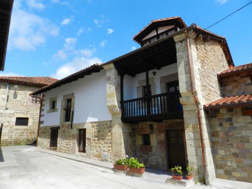 a building with a balcony on the side of it at Casona 1828 in Cabuerniga