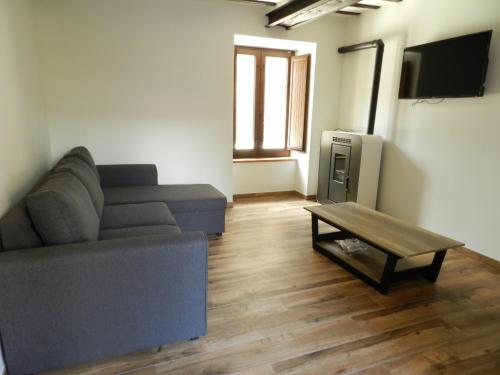 a living room with a couch and a coffee table at Casona 1828 in Cabuerniga