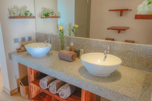 a bathroom with two sinks on a counter at The Puncak Lombok in Senggigi 