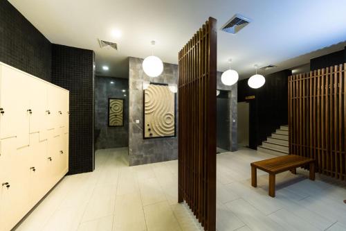 a dressing room with a bench and a staircase at Zen Next Khao Yai By ZV in Pak Chong