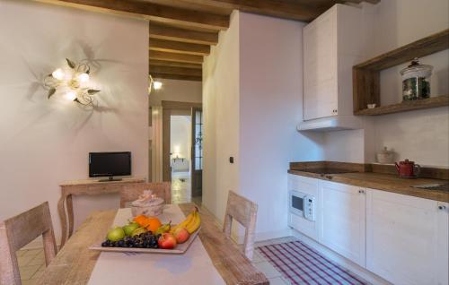 a kitchen with a table with a bowl of fruit on it at L'Altana City House in Brescia