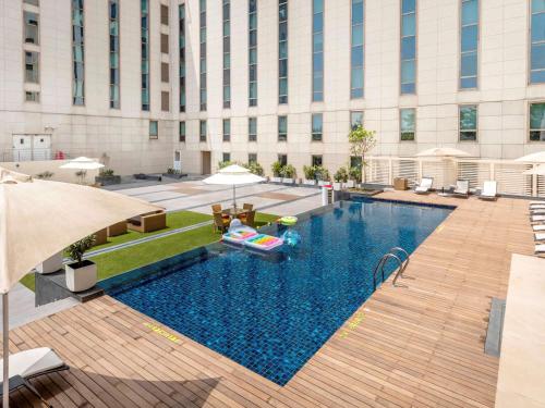 a swimming pool in the middle of a building at ibis New Delhi Aerocity - An Accor Brand in New Delhi