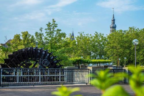 a metal sculpture in a park behind a fence at Quality Hotel Lippstadt in Lippstadt