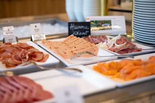 a buffet with different types of meats and cheese at Quality Hotel Lippstadt in Lippstadt