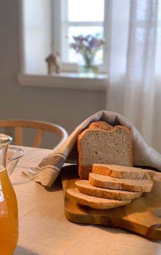 a loaf of bread sitting on a table with bread sticks at Bakkehuset Countryhouse in Skovby