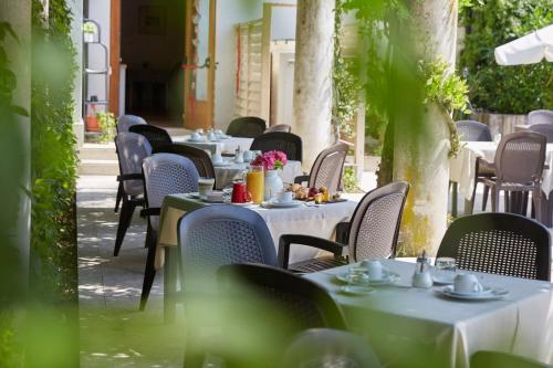 a row of tables and chairs with food on them at Hotel Villaguarda Prosecco Area in Follina