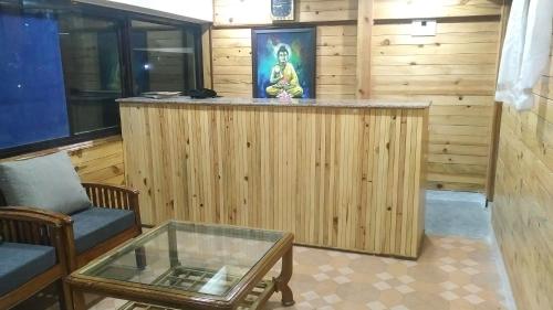 a living room with a bar with a table at Highland Village Resort in Dharmsala
