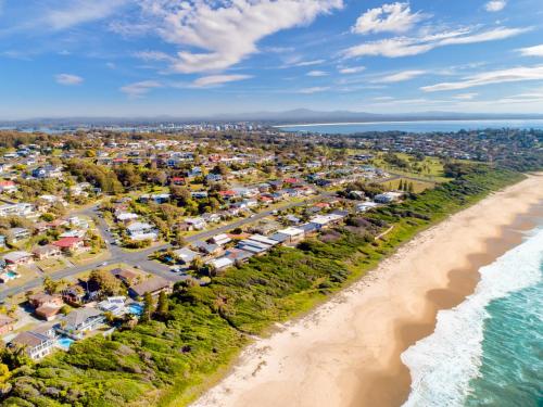 an aerial view of a resort next to the beach at Myley's Flat in Forster