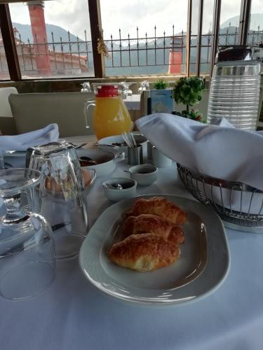 a white table with a plate of food on it at Hotel Metoxi in Spiliá