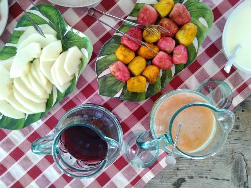 a table with a plate of fruit and a drink at Masseria Stellato in Nardò