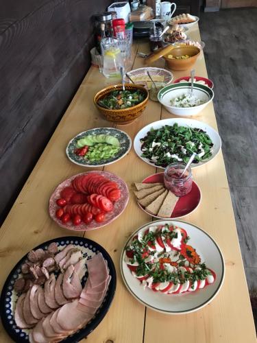 a table with many plates of food on it at Polana in Lipowiec