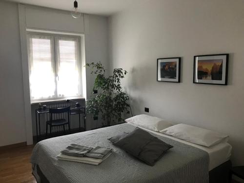 a bedroom with a bed and a window at Feel@Home Apartment+Rooms in Milan