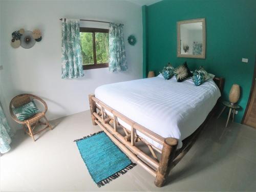 a bedroom with a large bed and a window at Carpe Diem Residence - Adults Only in Thong Sala