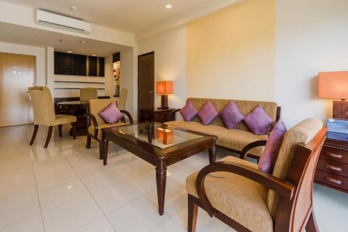 a living room with a couch and a table at Bintang Flores Hotel in Labuan Bajo