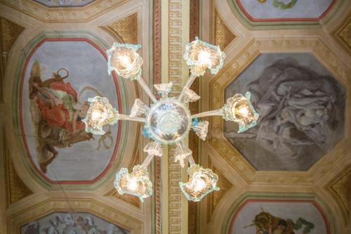 a chandelier hanging from the ceiling in a building at Hotel Europa in Ferrara